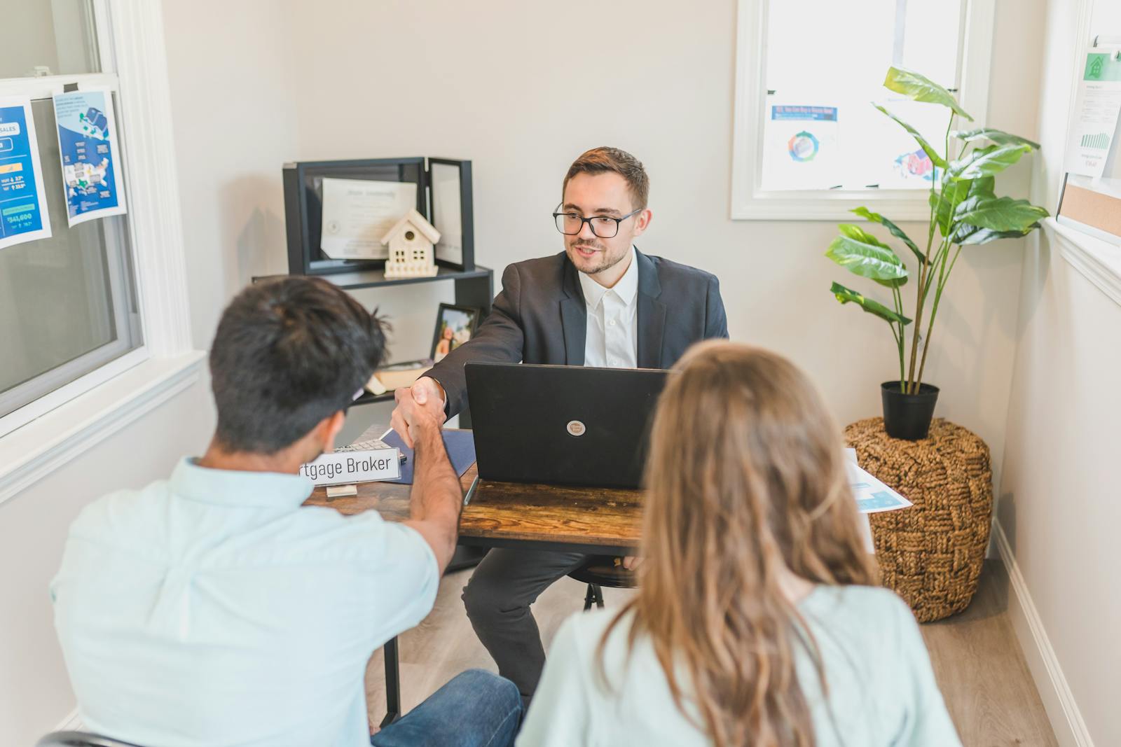 Borrowers reviewing mortgage documents with an advisor